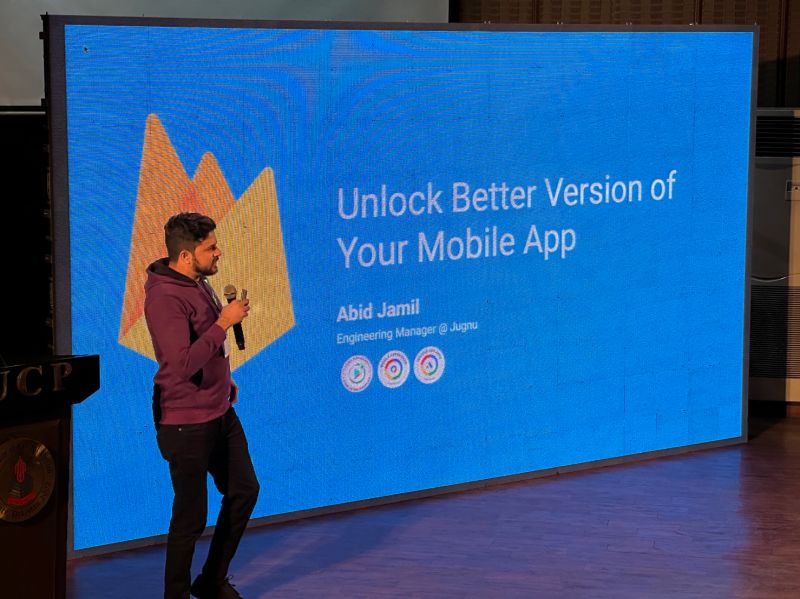 Abid Jamil beside the title slide for his Firebase Performance talk at DevFest Lahore 2022