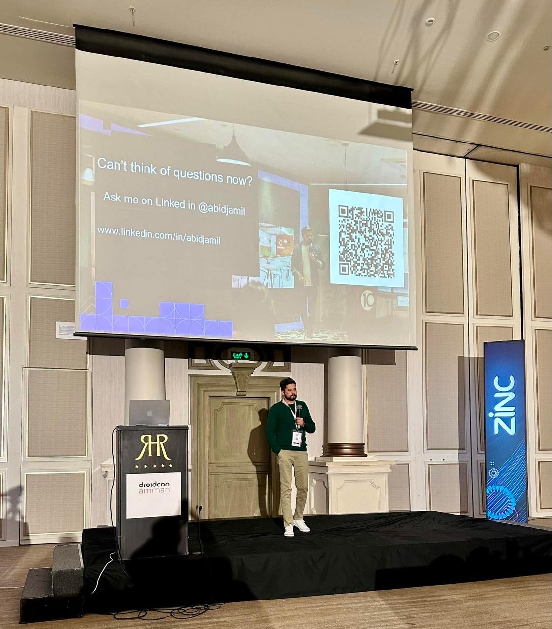Abid Jamil speaking on stage at droidcon Amman
